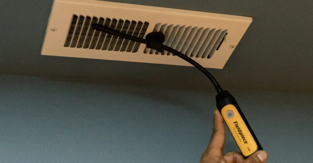Air duct cleaning inspection at a wall supply register