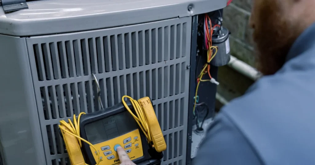 Technician servicing a heat pump, the work that decides how long a heat pump lasts