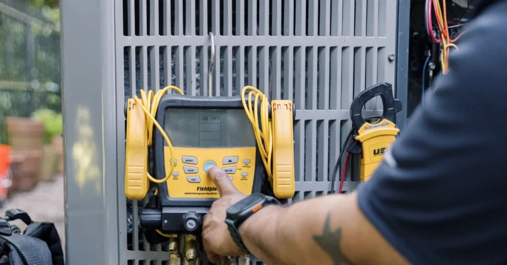 Technician measuring an outdoor unit to answer what size air conditioner do I need